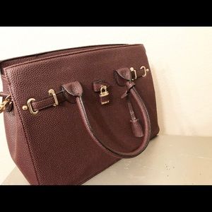 Top handle Handbag with lock.